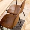 A set of 4 modern medieval style restaurant cushioned side chairs, equipped with soft cushions and black metal legs, suitable for kitchens, lounges